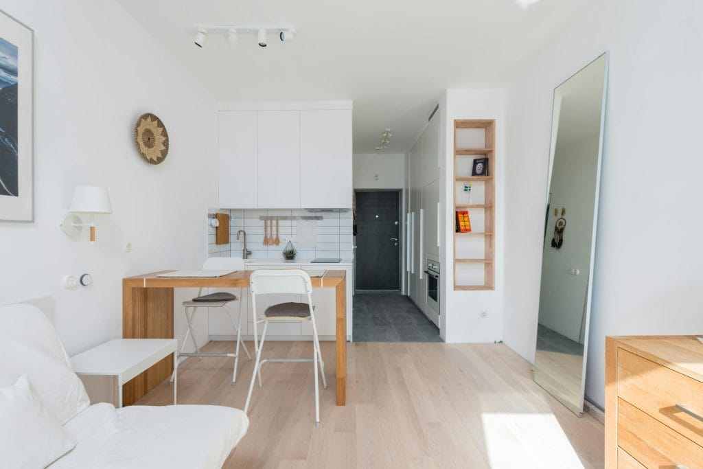 Bright and airy modern apartment with minimalist decor and open kitchen design.